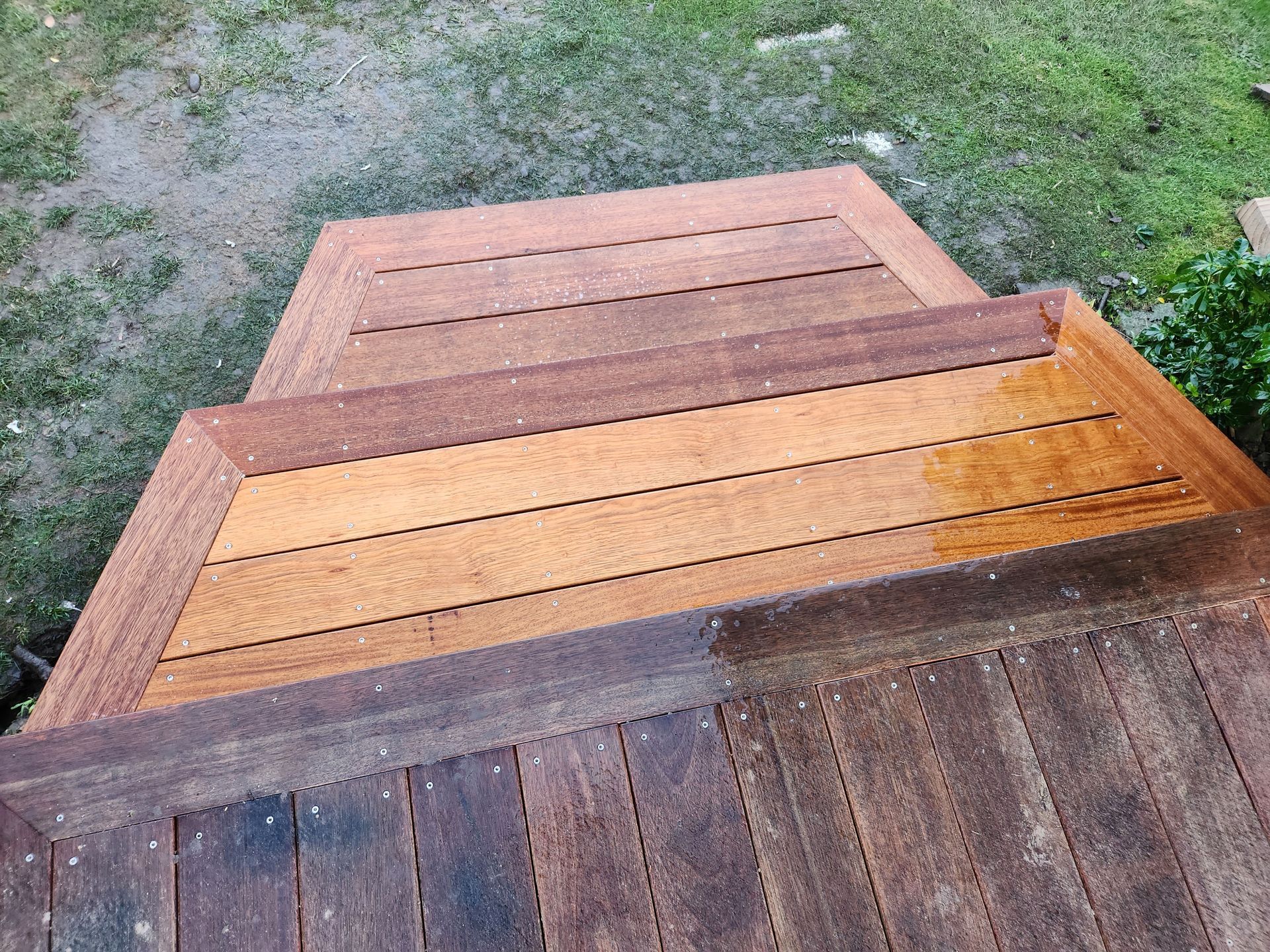 A wooden deck with stairs leading up to it.