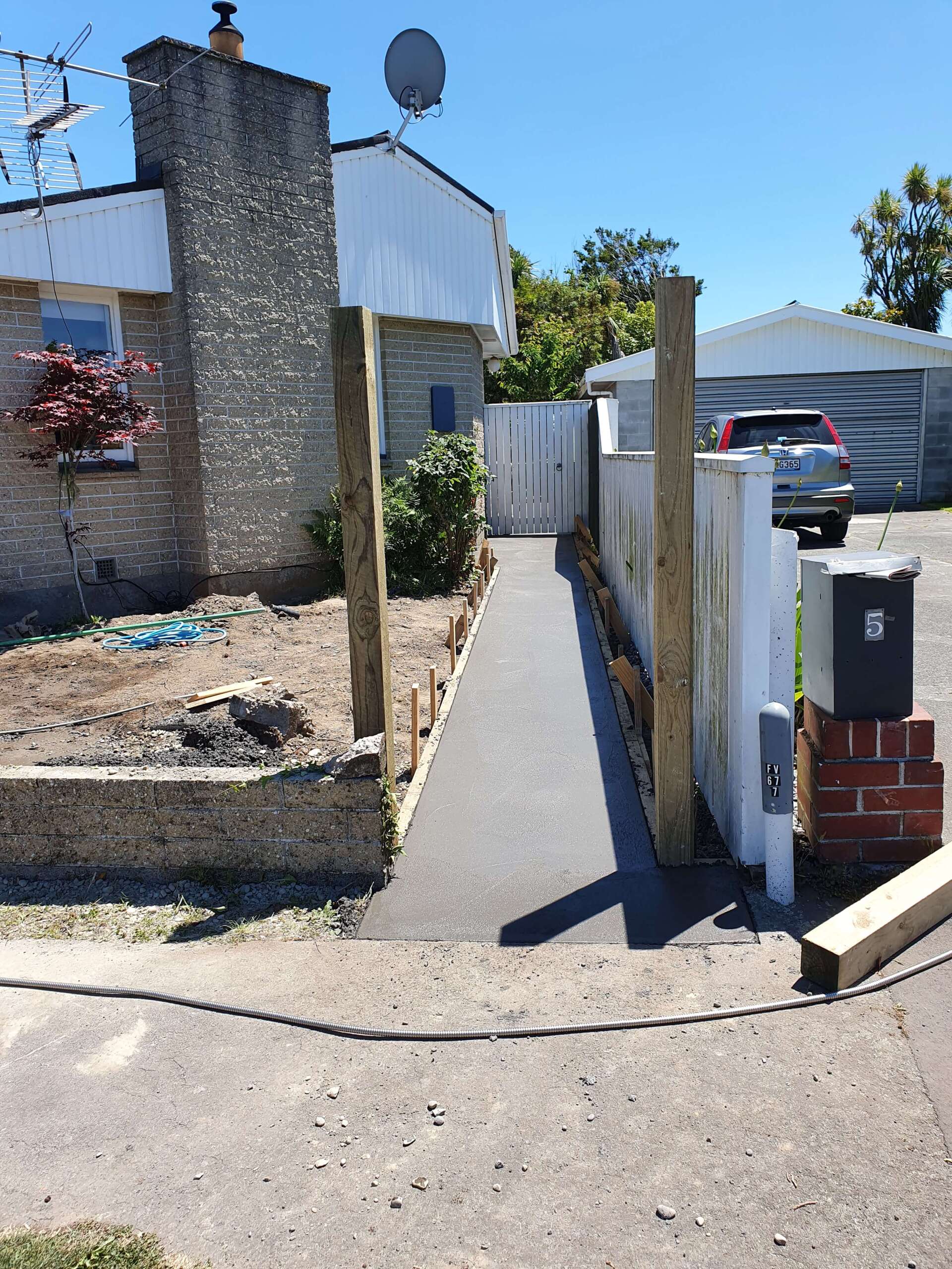 A walkway is being built in front of a house