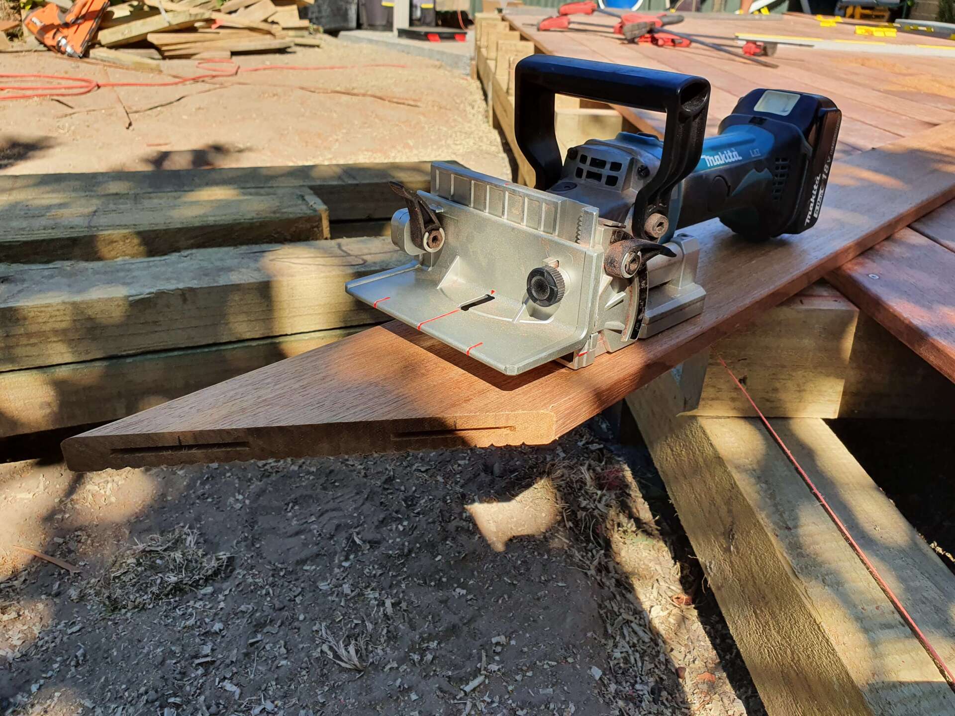 A circular saw is sitting on top of a piece of wood.
