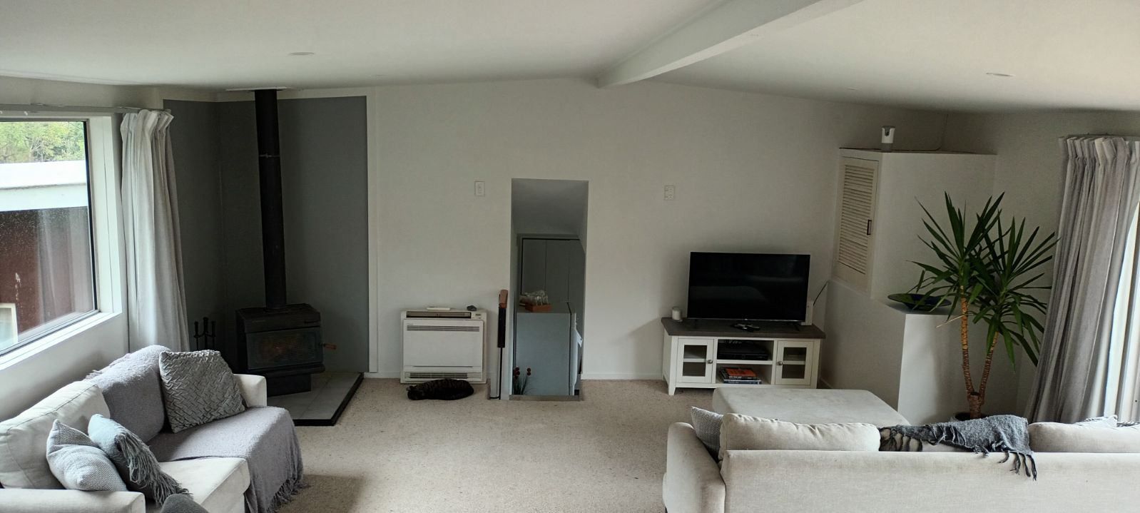 A living room filled with furniture and a television.