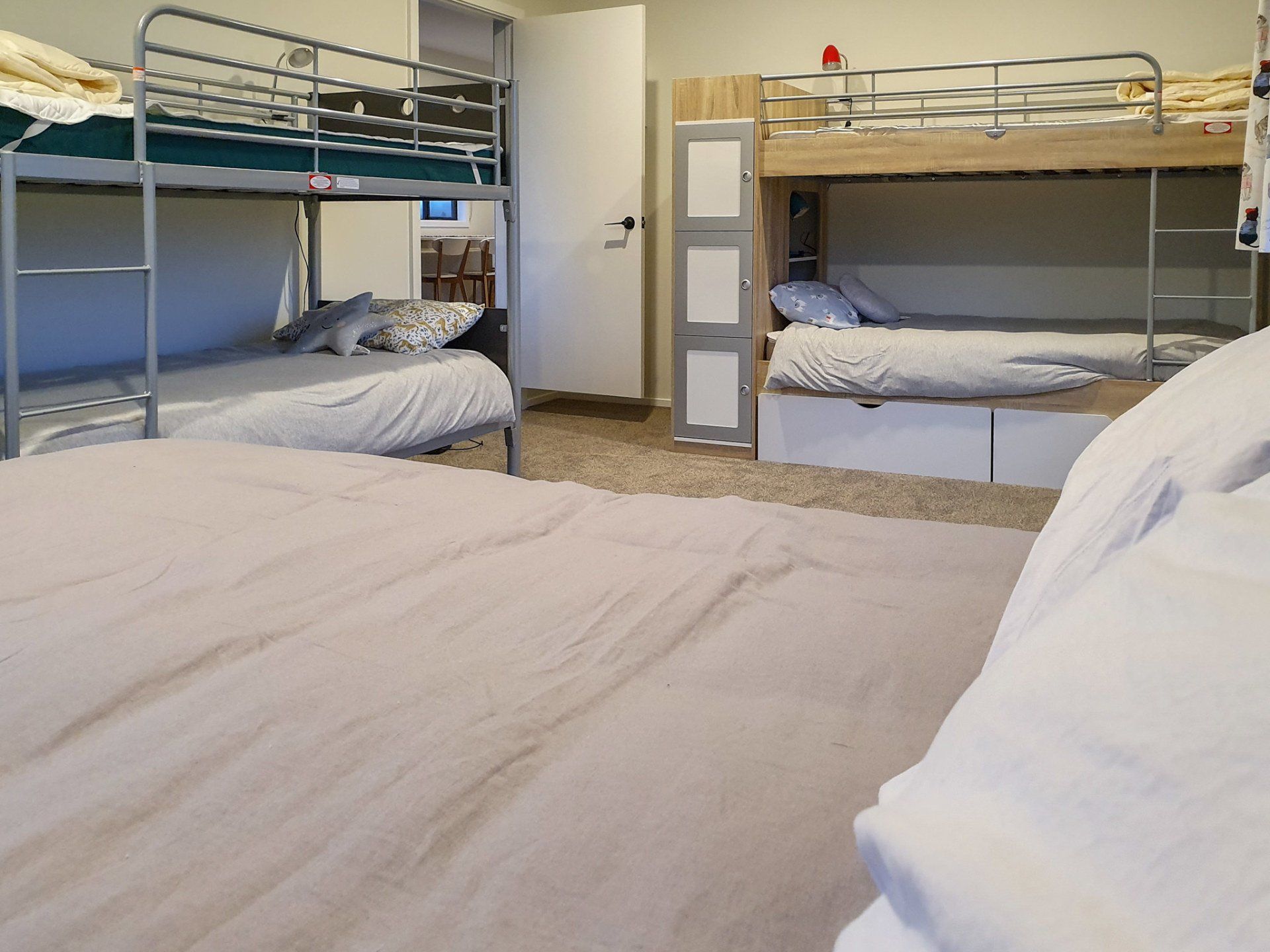 A bedroom with bunk beds and a large bed