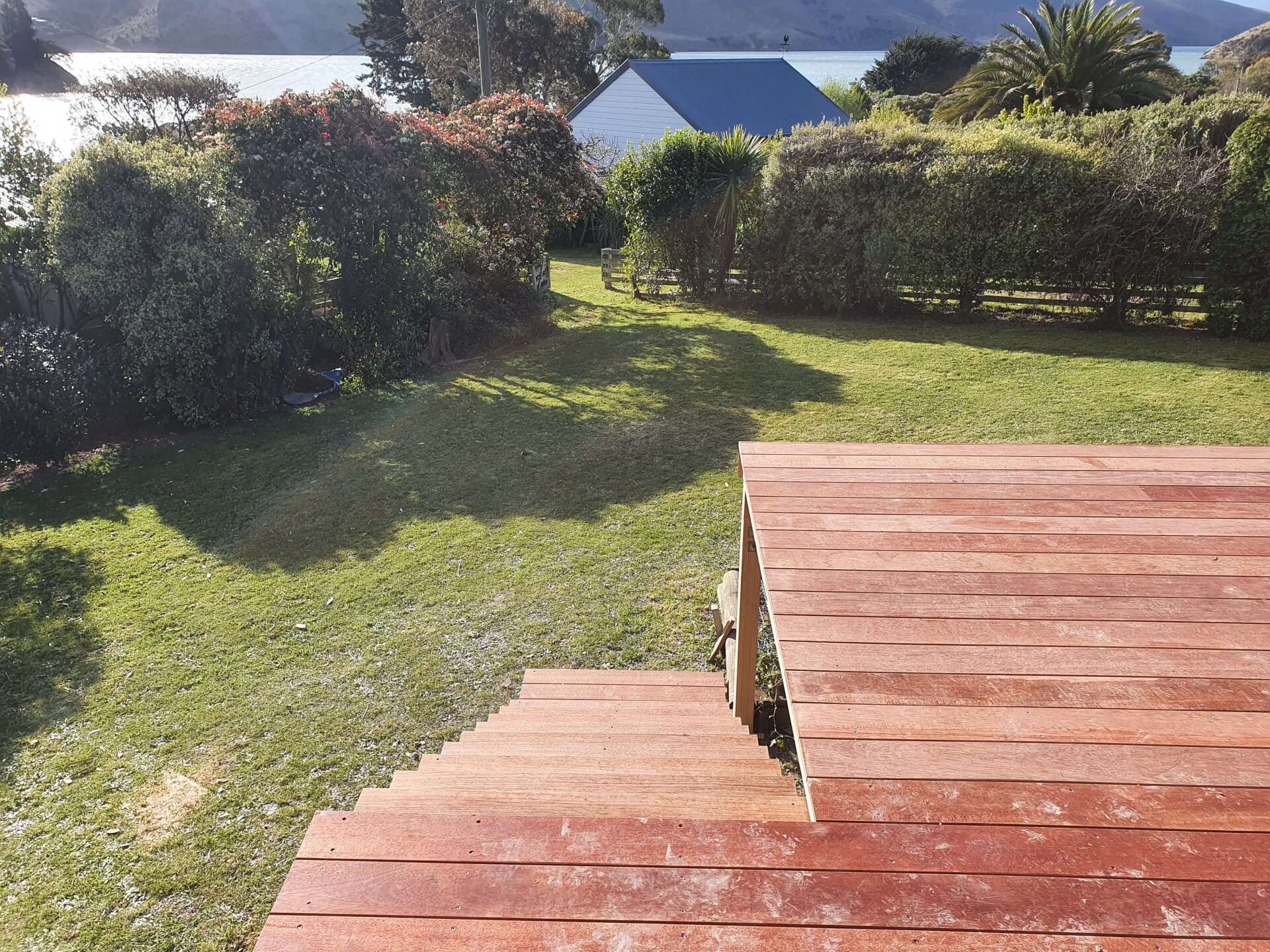 A wooden deck with stairs leading up to it