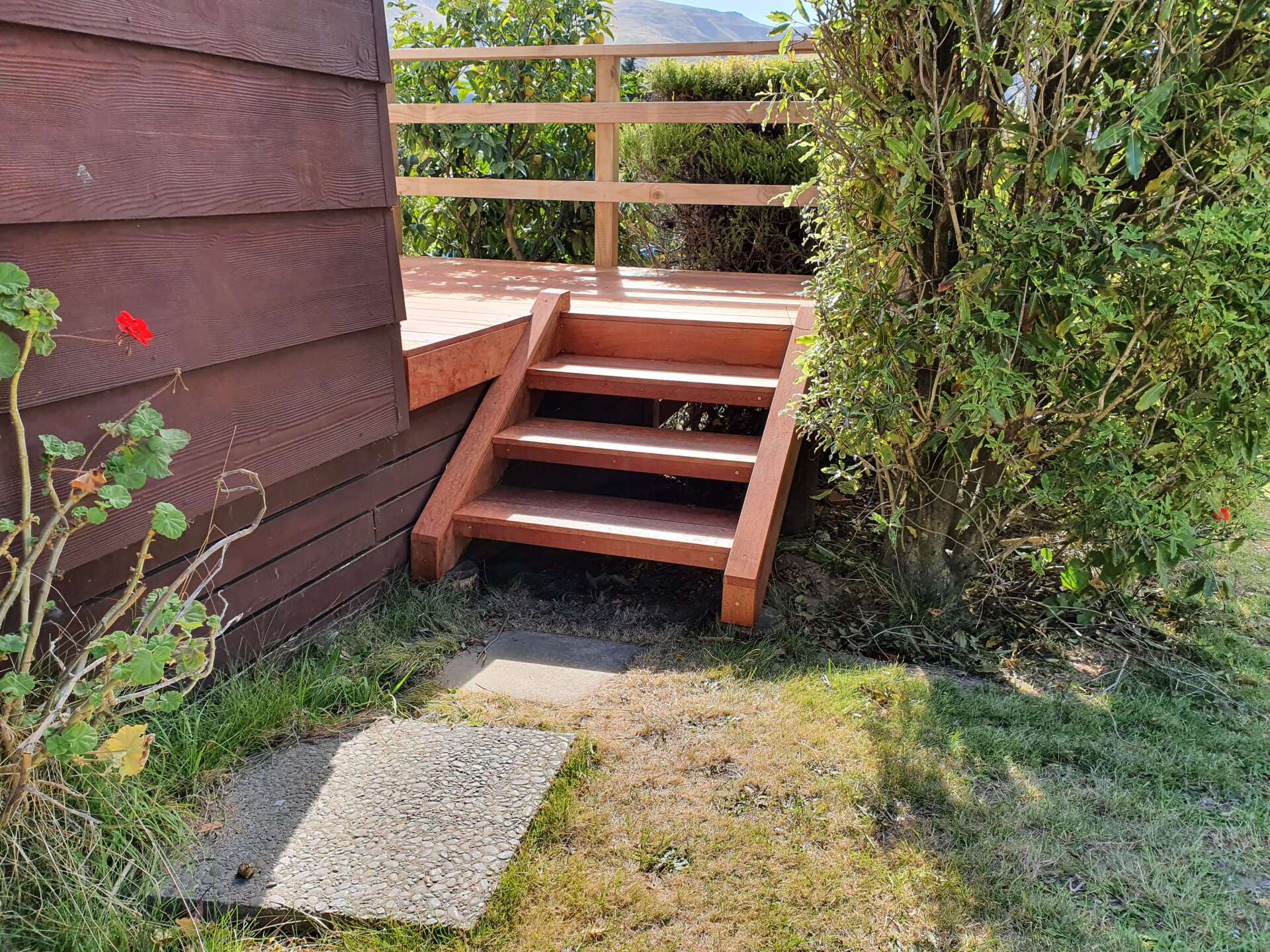 A wooden deck with stairs leading up to it.