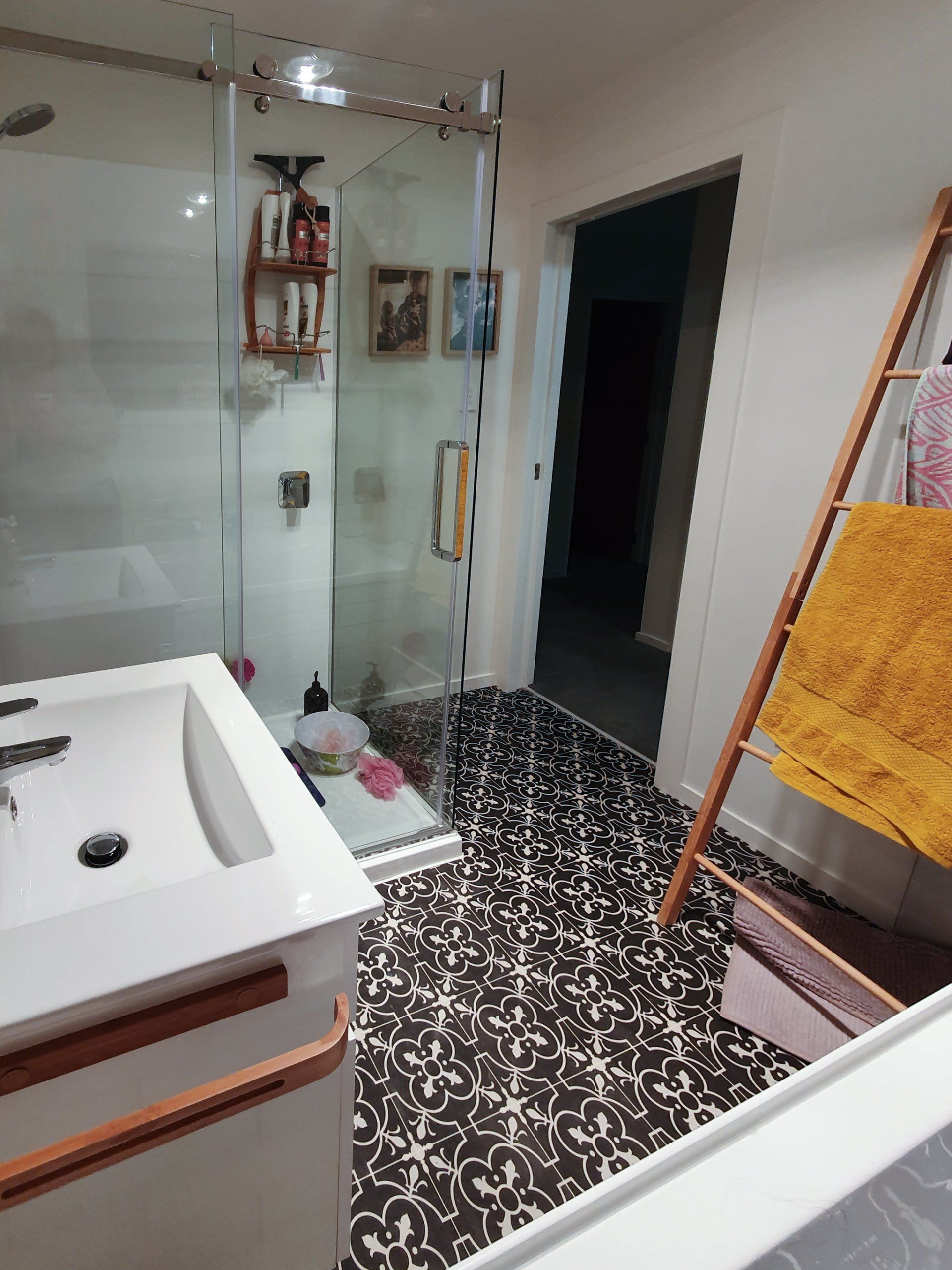 A bathroom with a sink and a walk in shower