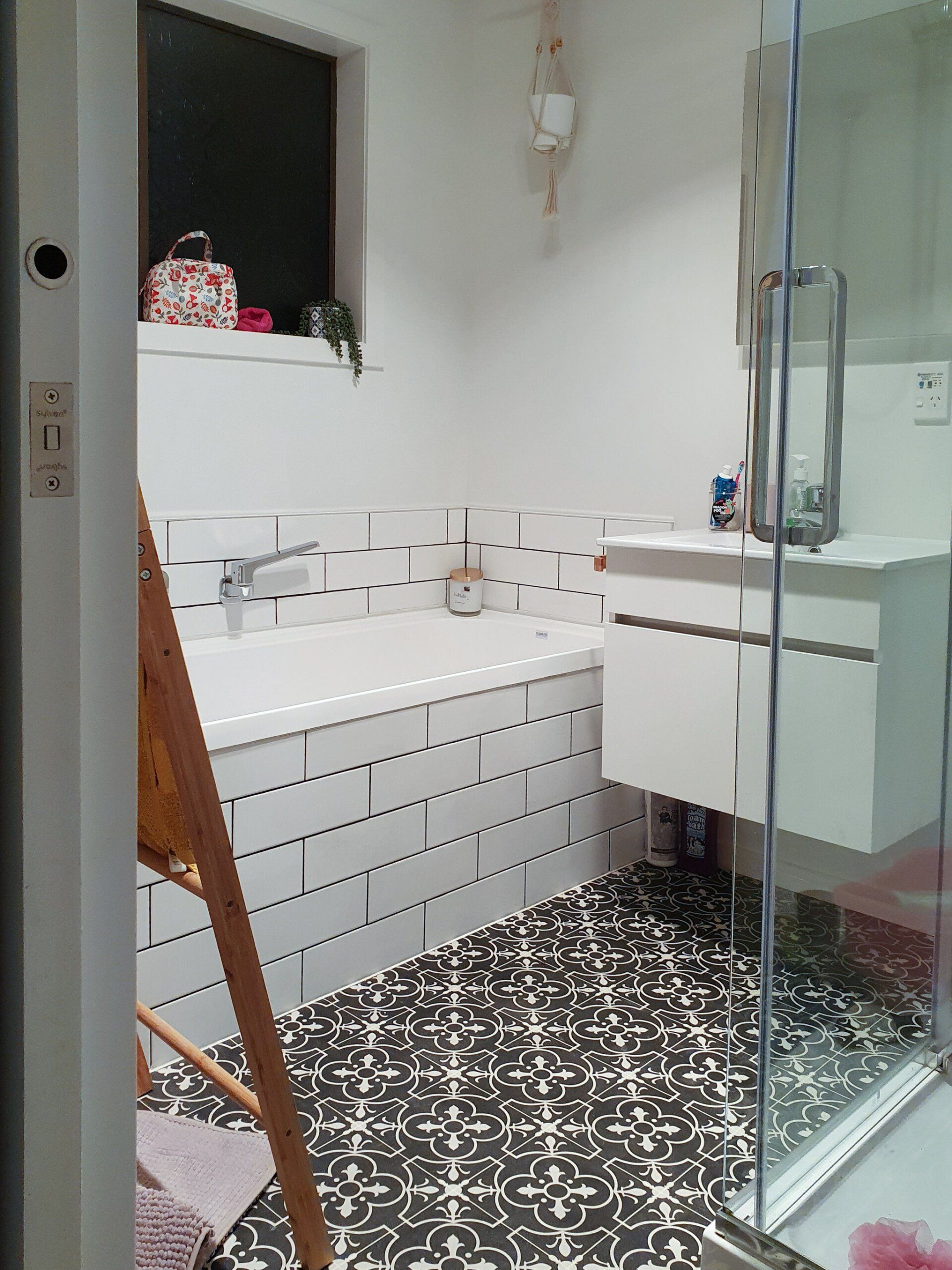 A bathroom with a bathtub , sink , and shower.