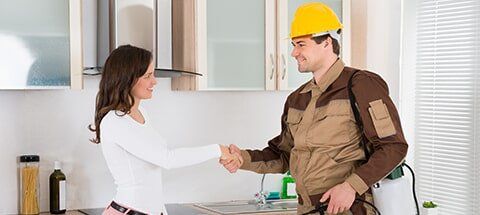 Client and Worker Shaking Hands — Pest Control Services in Houston, TX