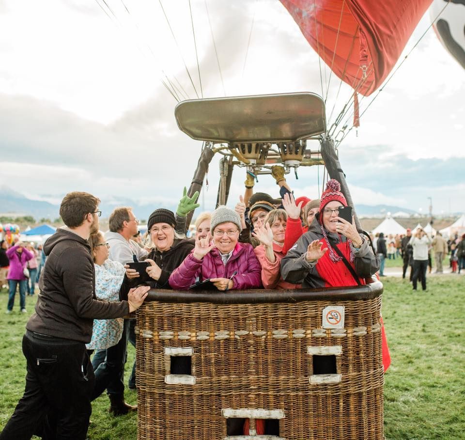 A group of people are sitting in a hot air balloon.