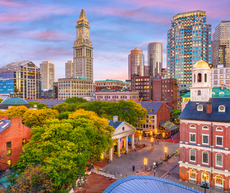An aerial view of a city with a clock tower in the background.
