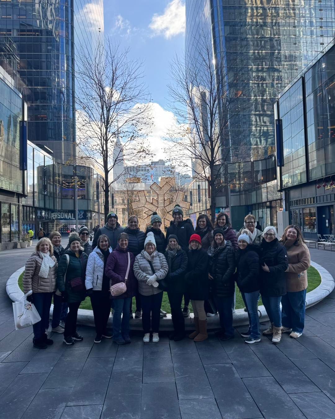 A group of people are posing for a picture in front of a building.