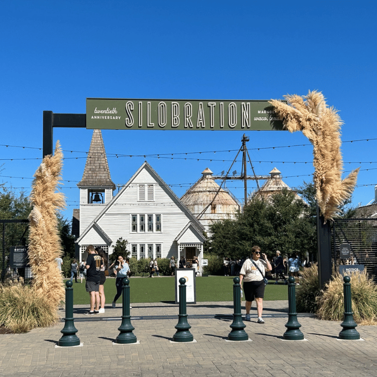 Entrance arch to Silobration event with buildings and people.