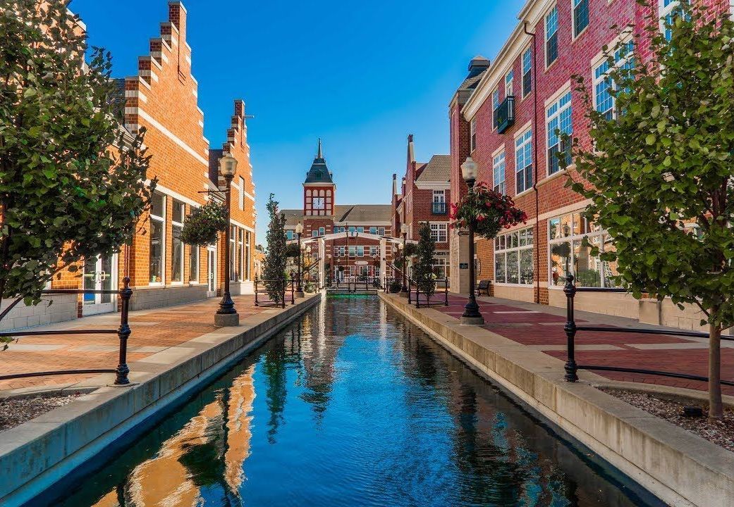 There is a canal between two buildings in the middle of a city.