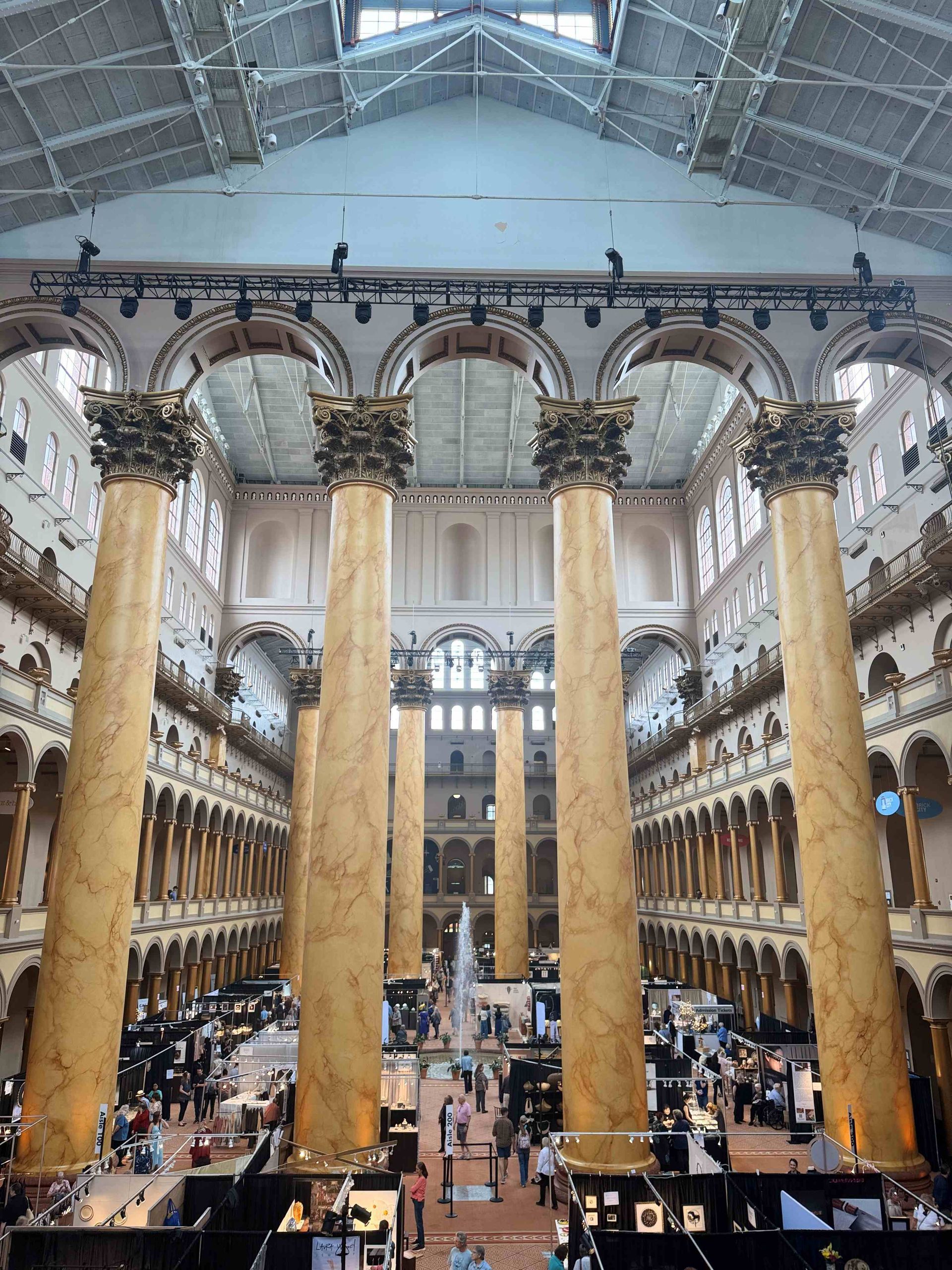 The inside of a large building with columns and arches