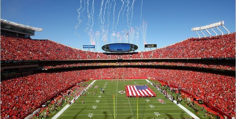 A football stadium with fireworks going off in the sky