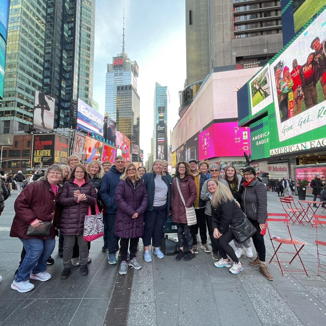 A group of people posing for a picture in NYC.