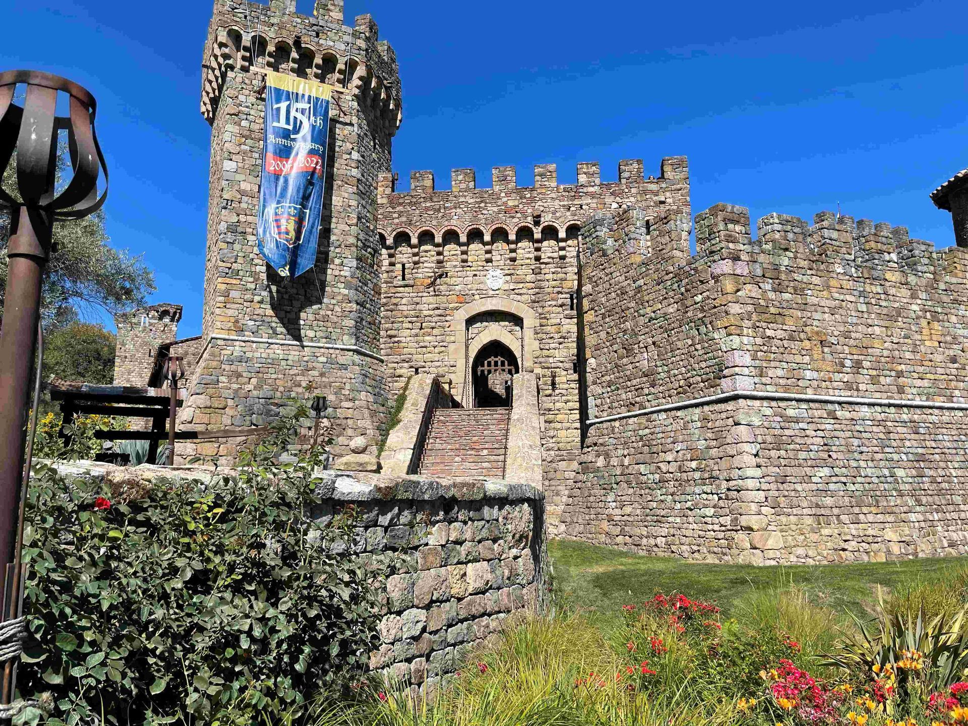 A large stone castle with a flag hanging from the top of it.