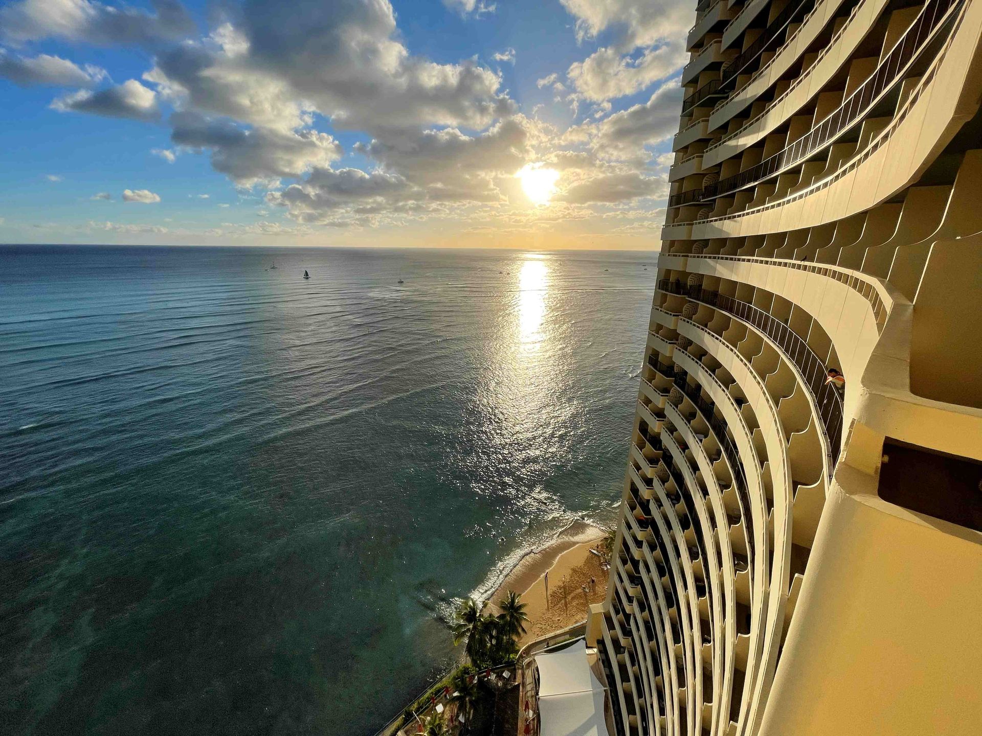 A view of the ocean from a hotel room at sunset.
