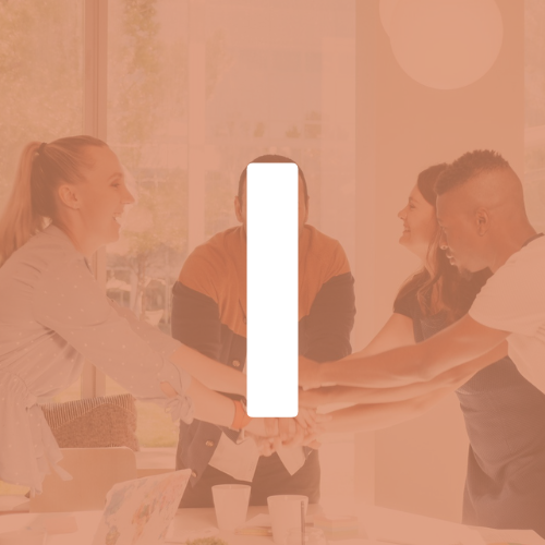 A group of people are putting their hands together in a circle.