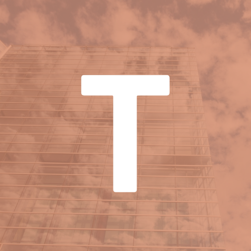 The letter t is on a building with a cloudy sky in the background.