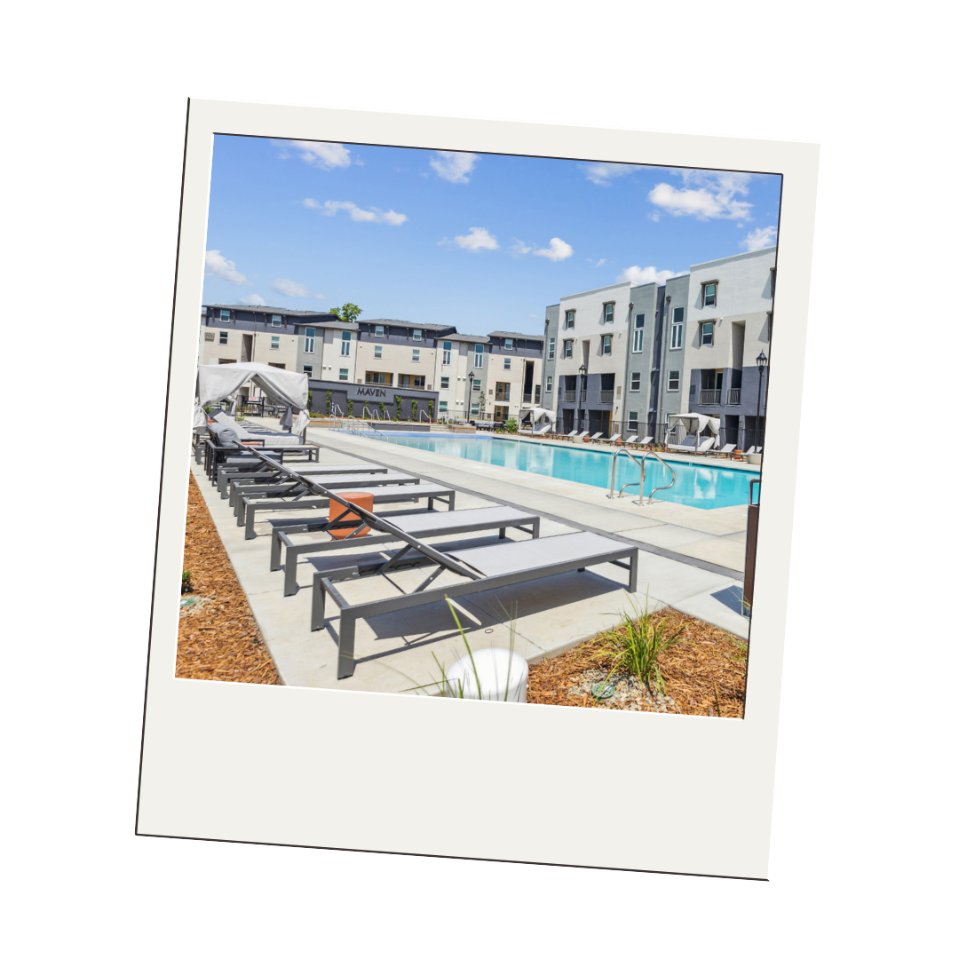 A polaroid picture of a swimming pool with lounge chairs in front of a building.