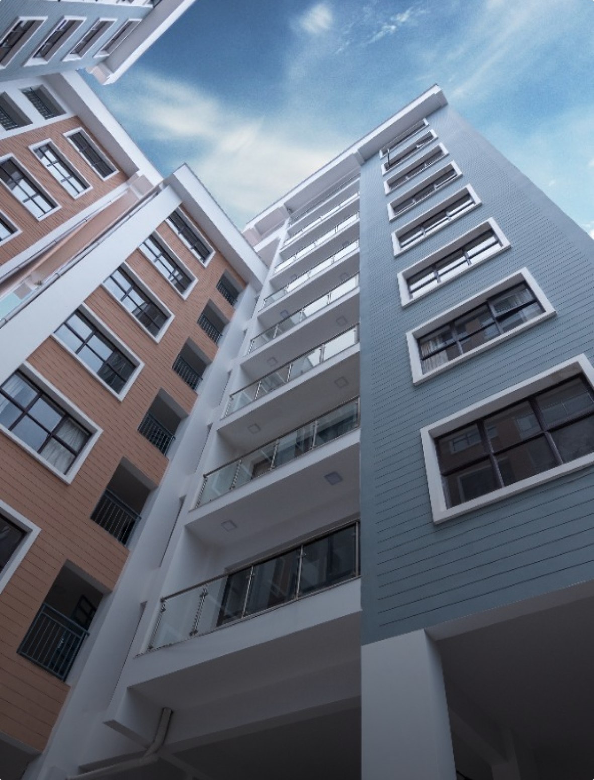 Looking up at a tall building with a blue sky in the background