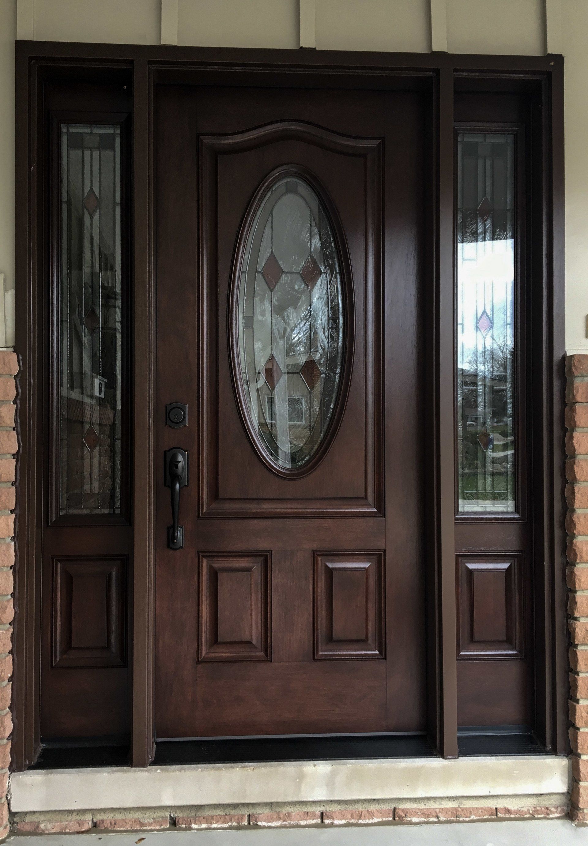 A brown door with a stained glass window