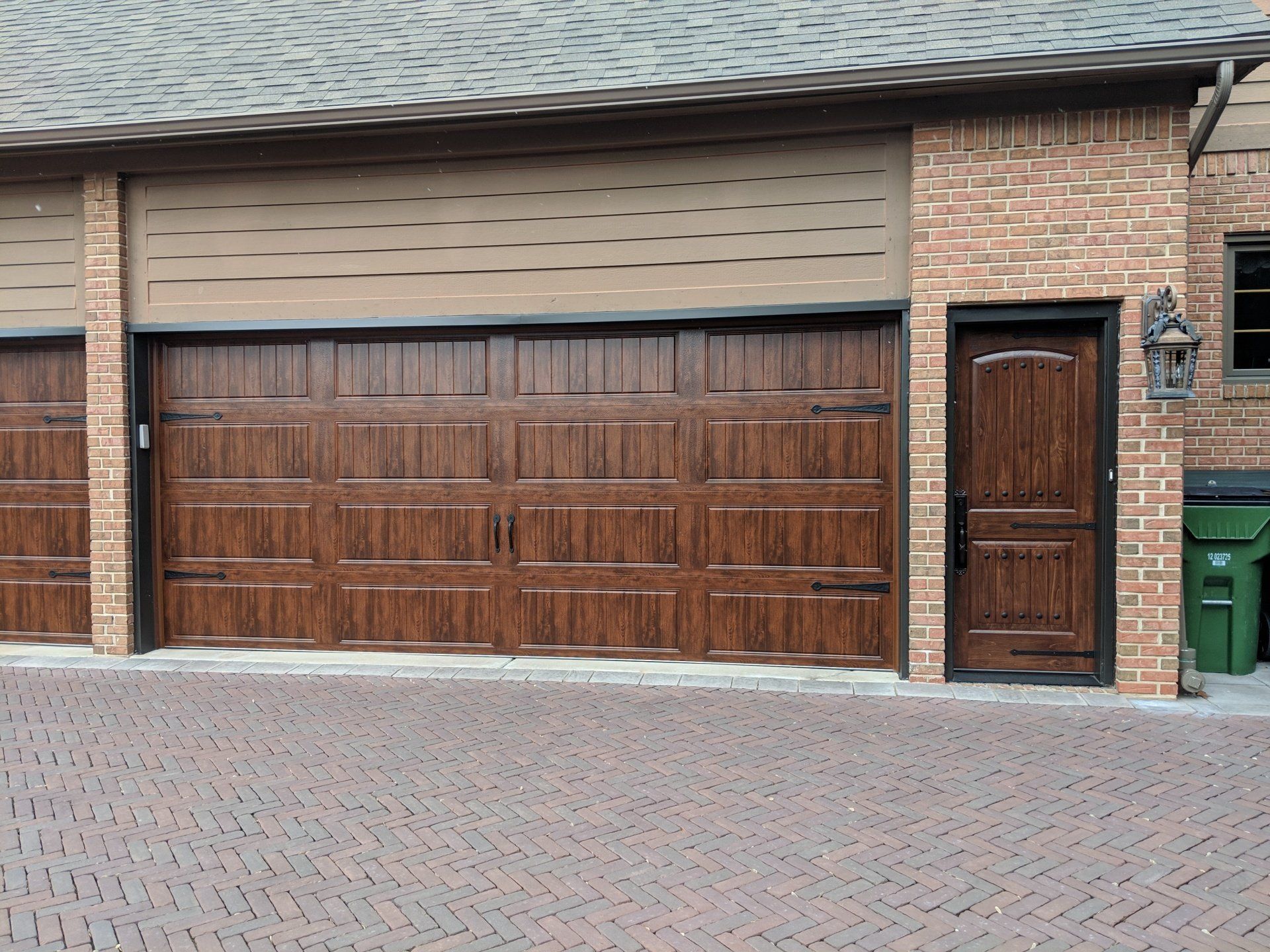 A brick building with a wooden garage door