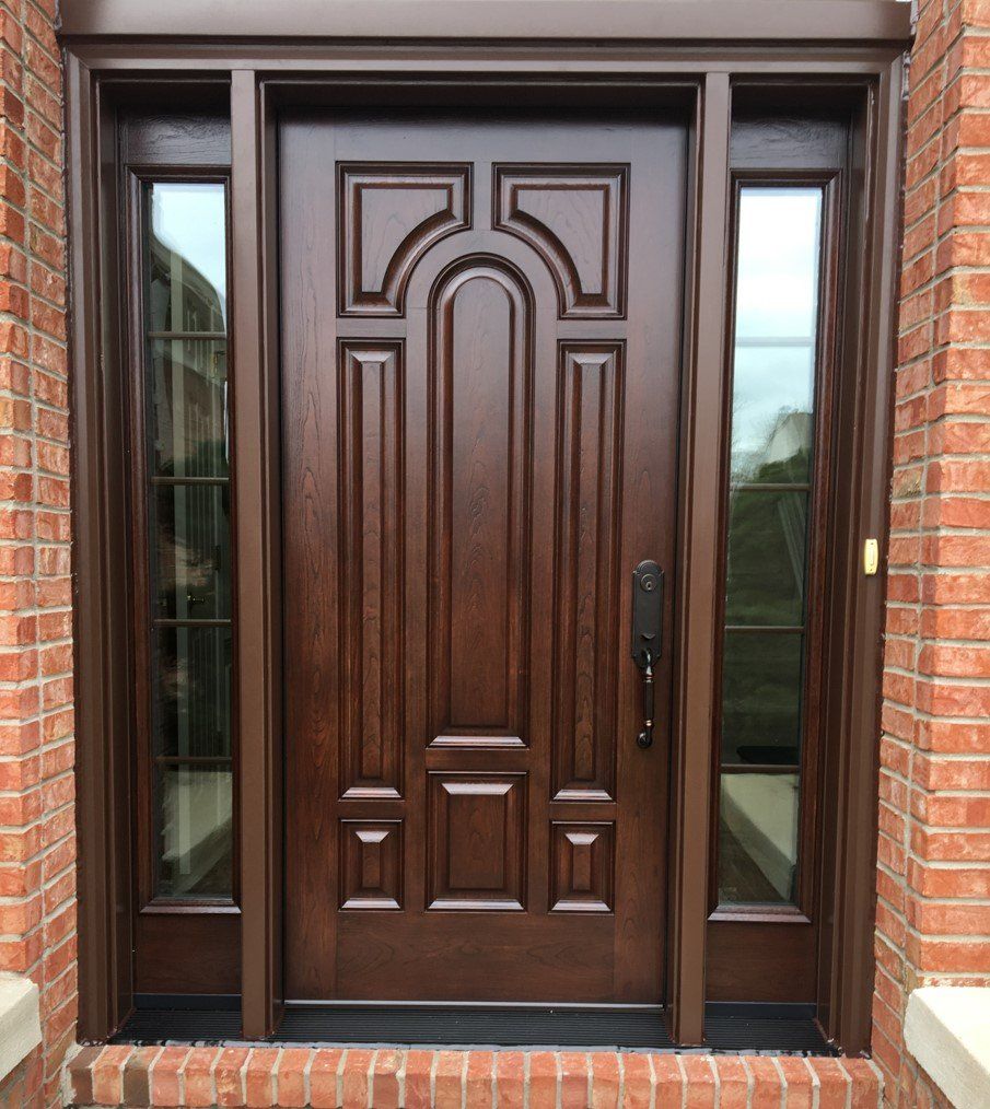 A brown door with a brick wall behind it
