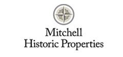 The logo for mitchell historic properties has a compass on it.