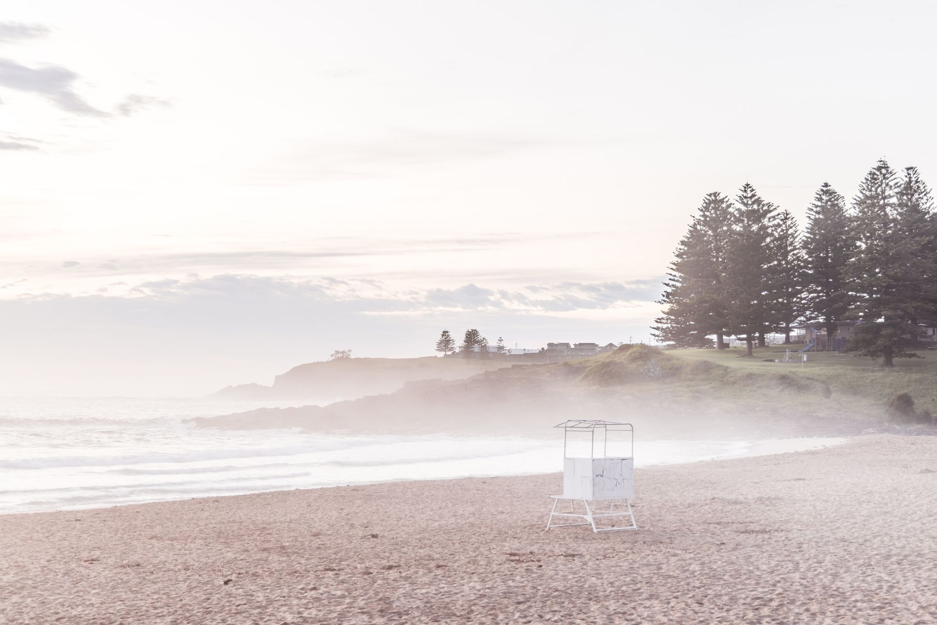 Waves Crash on a Rocky Shore, Cliffs, Bathed in Hazy Sunlight — Dr John Salmon, Kiama Family Dental In Kiama, NSW