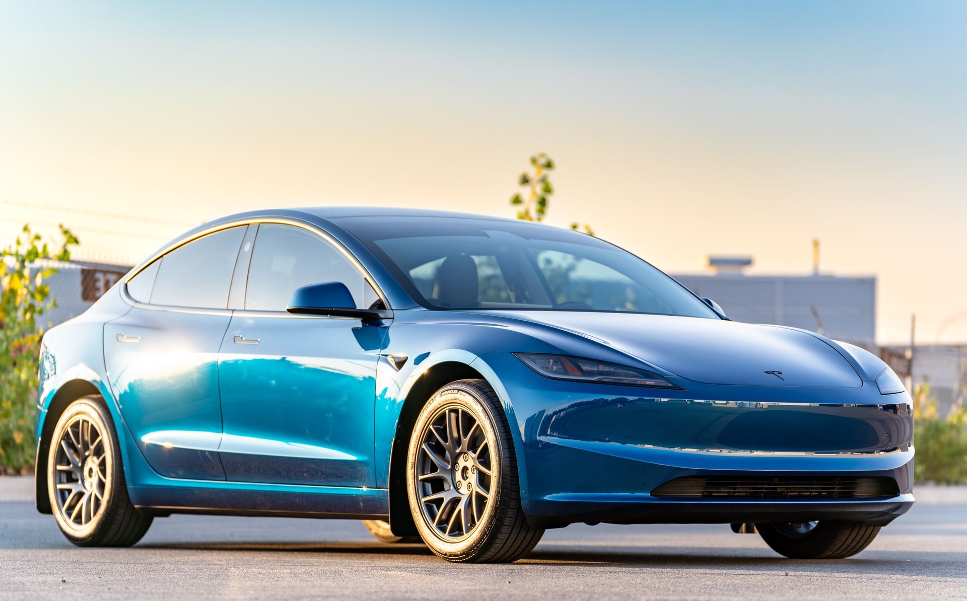 a blue Tesla Model 3 on the street
