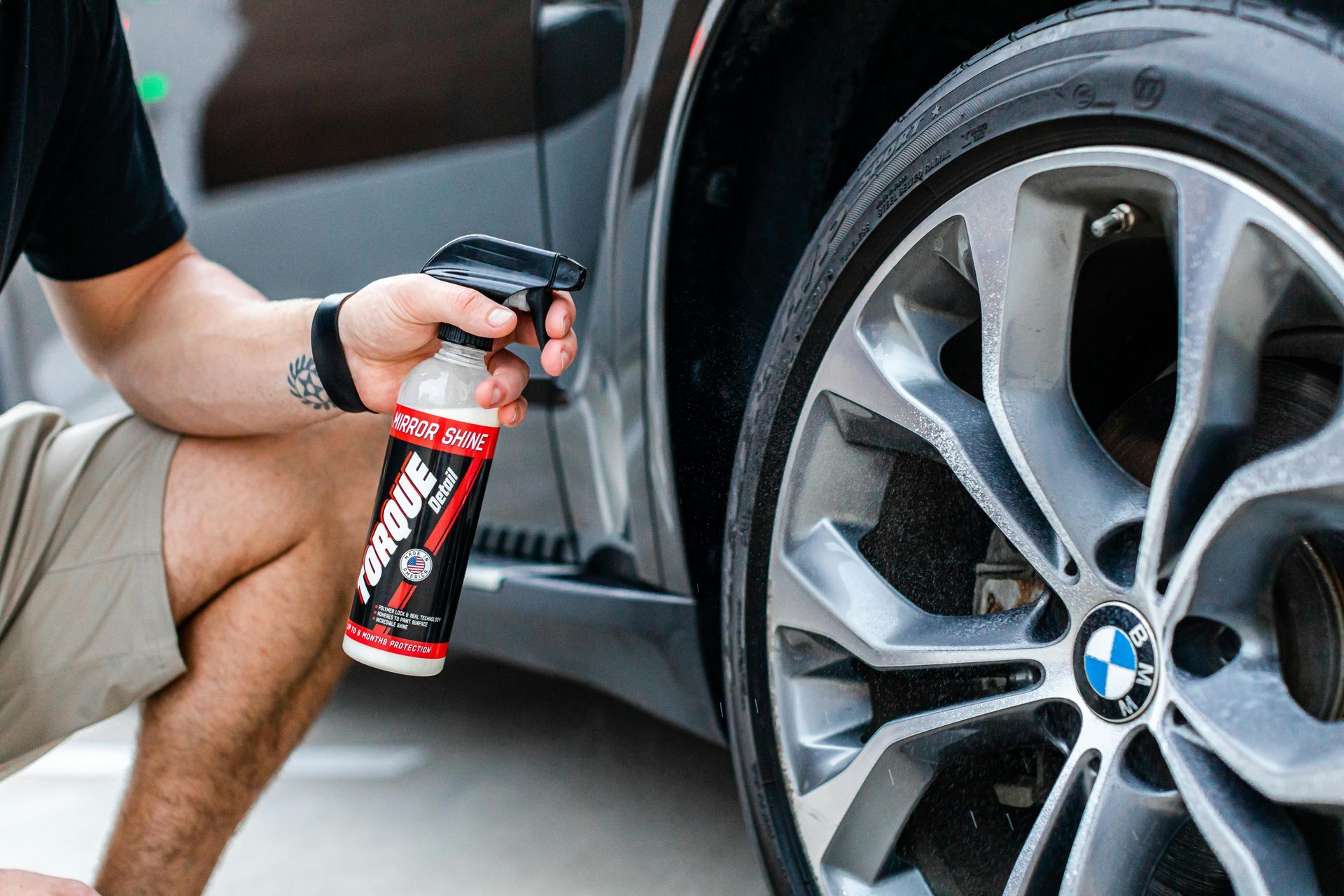 A man is working on a tire in a garage.