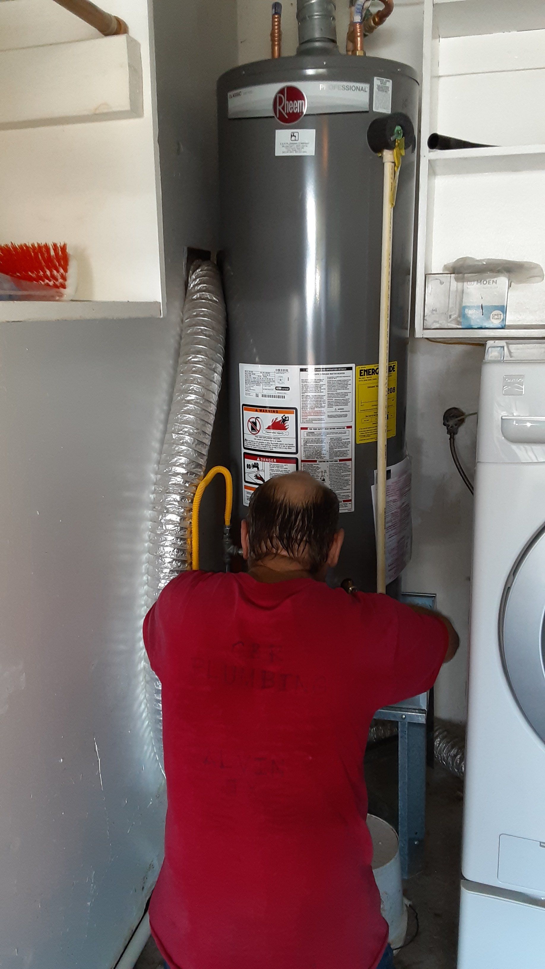 Man Fixing the Heater — Alvin, TX — C and R Plumbing