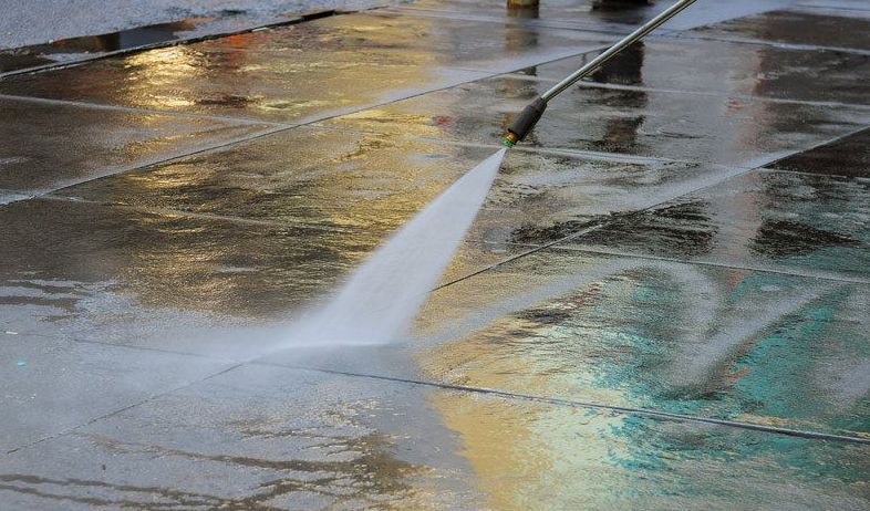 A Person is Using a High Pressure Washer — Magic Wand Roof Restoration & Painting in Tweed, NSW