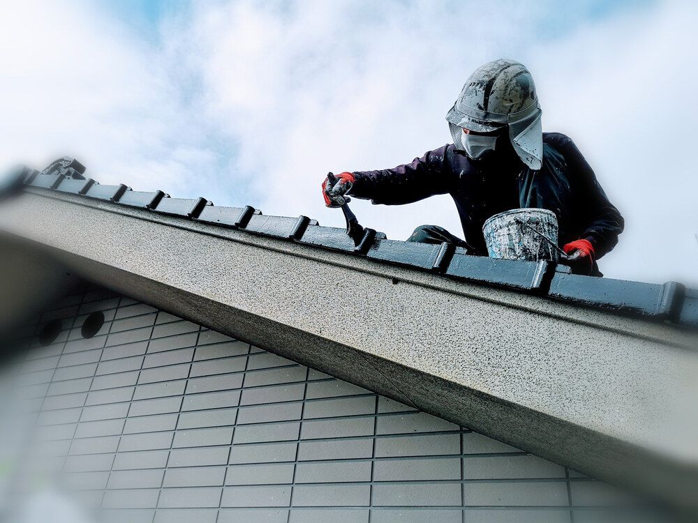 A Man is Working on the Roof — Magic Wand Roof Restoration & Painting in Kingscliff, NSW