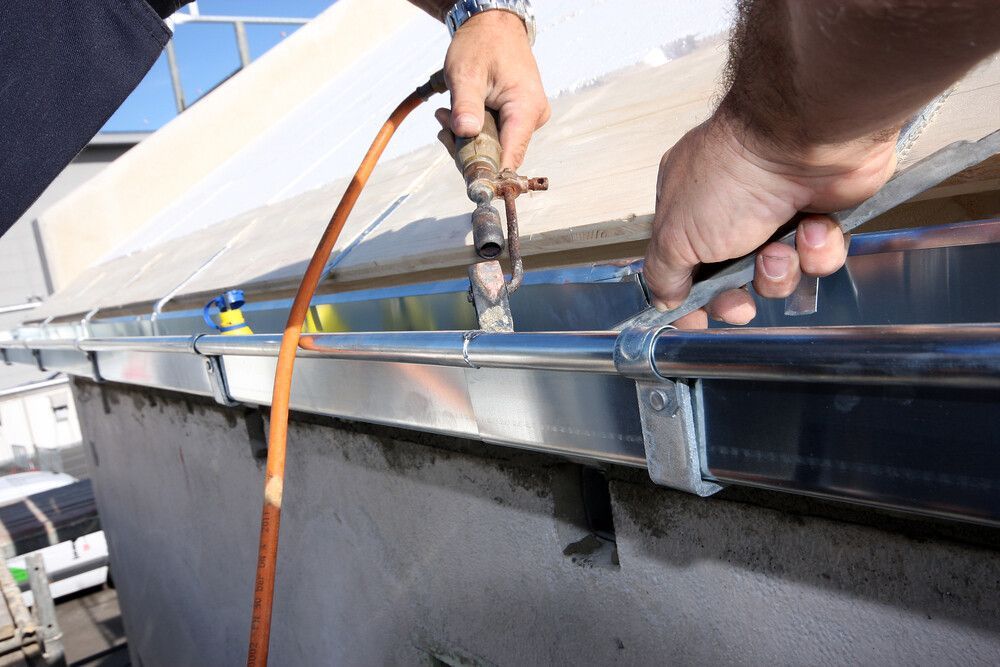 A man is Working on a Gutter — Magic Wand Roof Restoration & Painting in Mermaid Beach, QLD