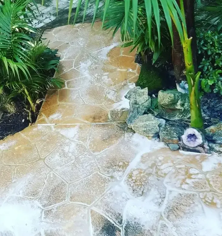 A Sidewalk Is Being Cleaned— Magic Wand Roof Restoration & Painting in Mermaid Beach, QLD