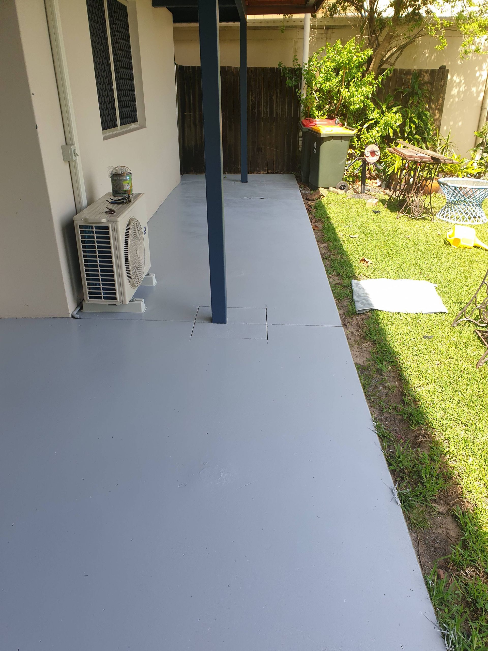 A Man is Standing on a Ladder Painting the Ceiling — Magic Wand Roof Restoration & Painting in Tweed, NSW