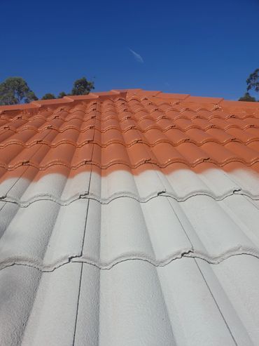 Two Men Are Painting the Roof of a House — Magic Wand Roof Restoration & Painting in Mermaid Beach, QLD