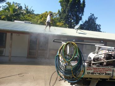 A Couple of People Are Working on a Roof — Magic Wand Roof Restoration & Painting in Mermaid Beach, QLD