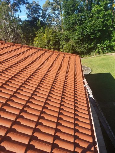 Two Men Are Working on the Roof of a Building — Magic Wand Roof Restoration & Painting in Mermaid Beach, QLD