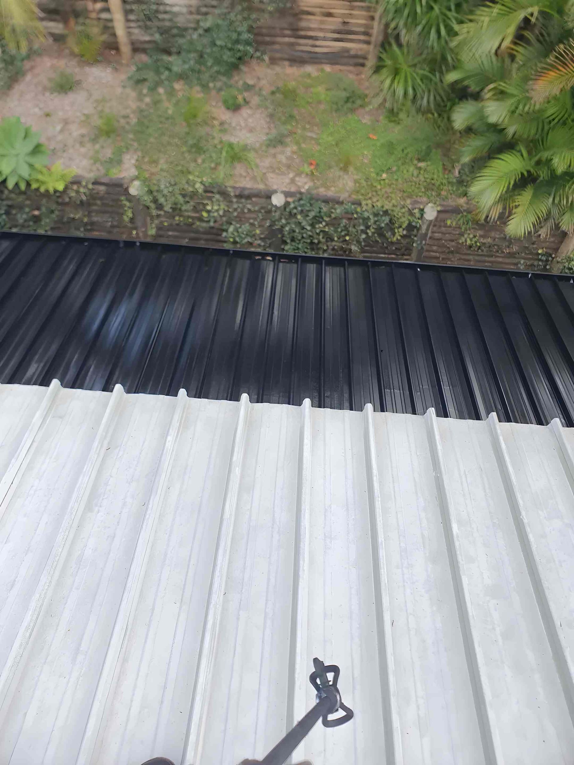 The Roof of a Building is Being Painted — Magic Wand Roof Restoration & Painting in Mermaid Beach, QLD