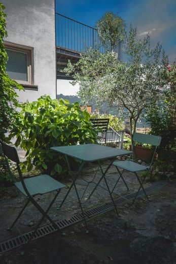 A table and chairs are sitting on a patio in front of a house.