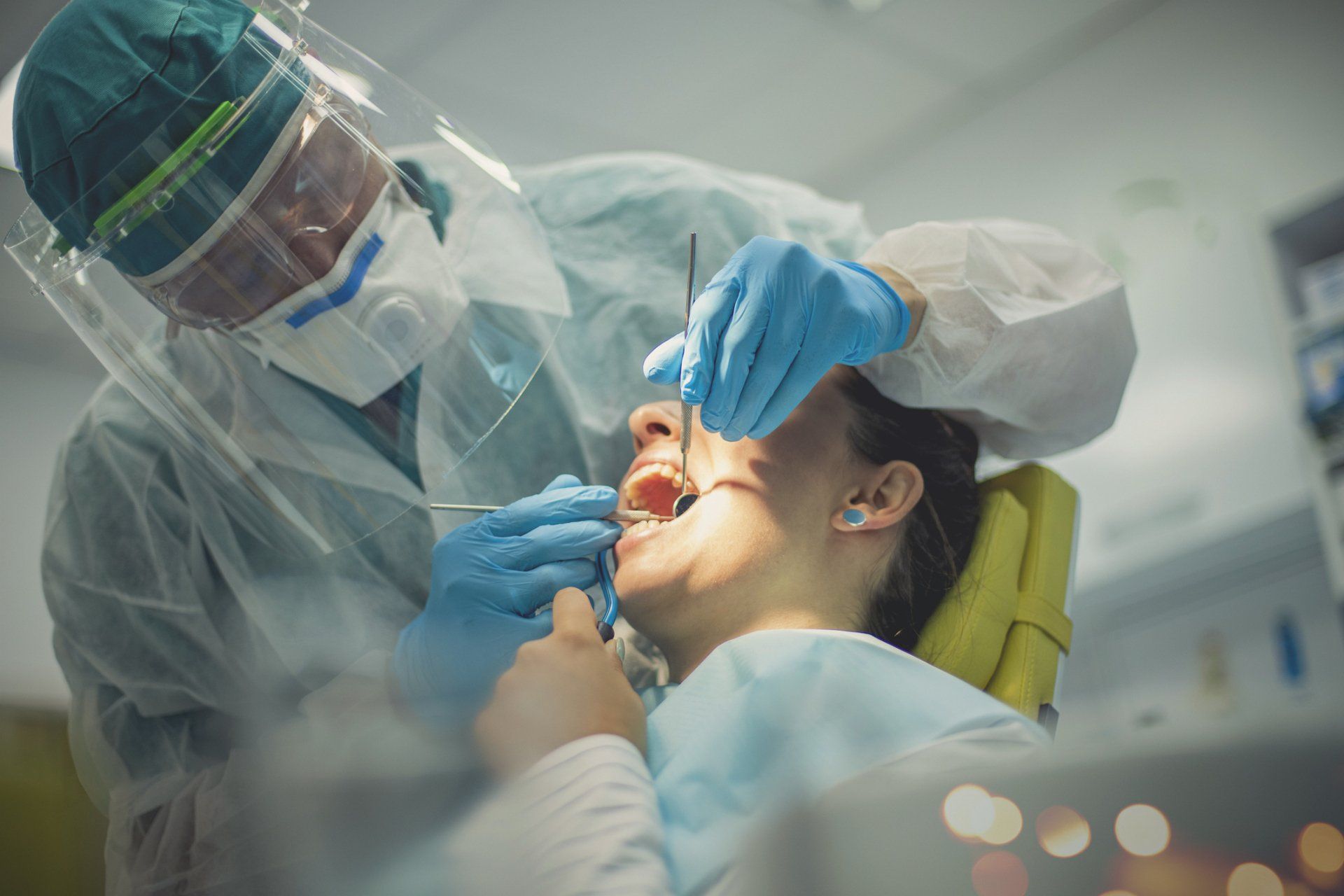 Woman in the chair has her mouth opened and examined — Madison, WI — East Grove Dental
