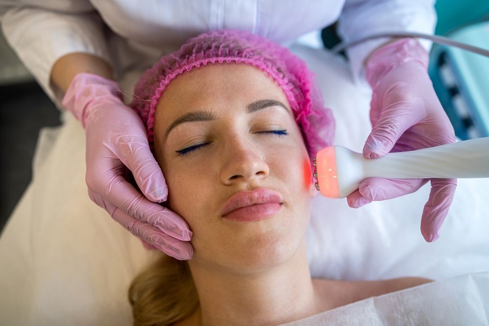 A Woman Is Getting A Facial Treatment At A Skin Clinic — Mackay Skin Clinic In Nebo, QLD