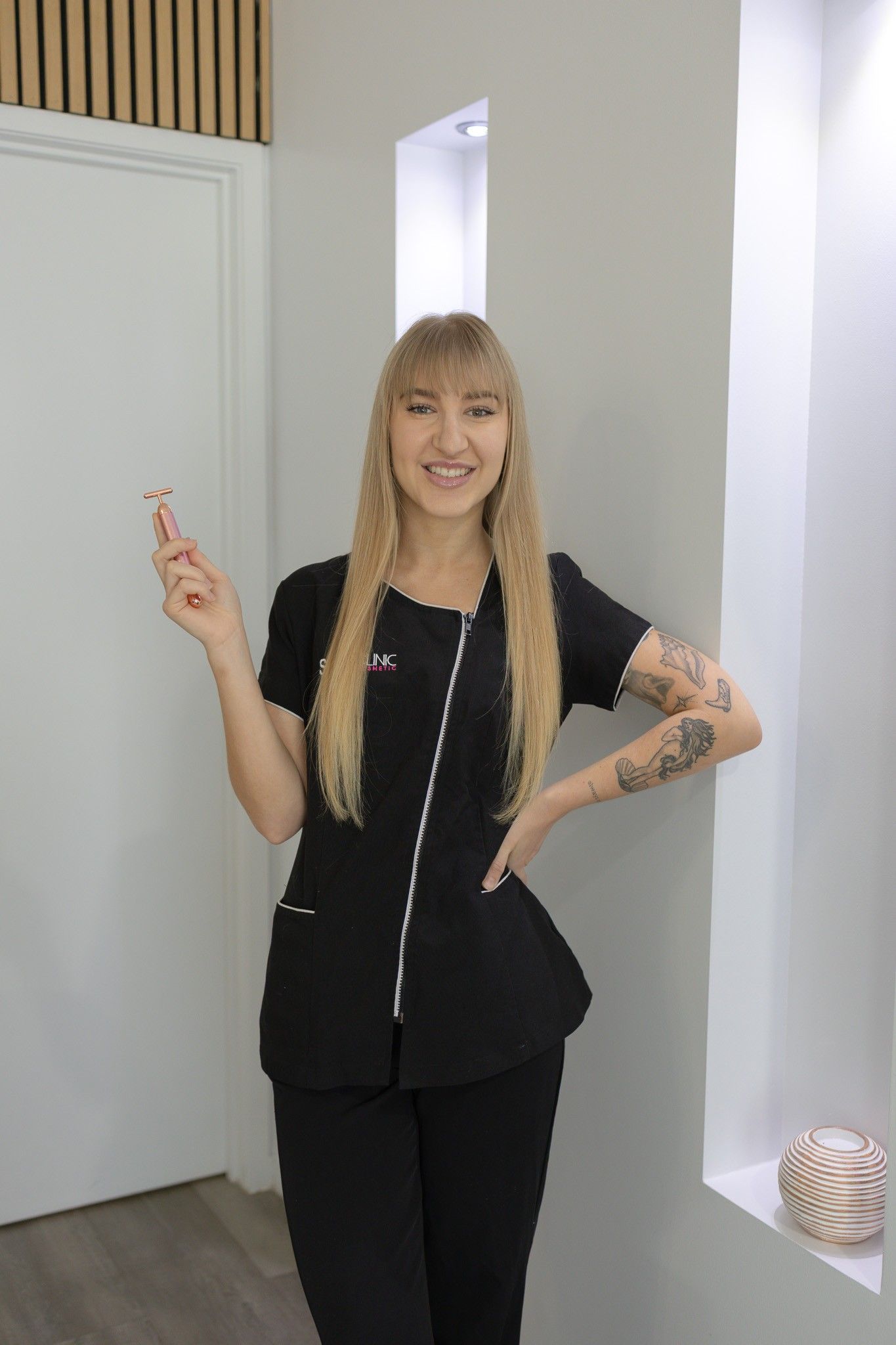 A Woman Is standing holding a beauty tool— Mackay Skin Clinic In North Mackay, QLD