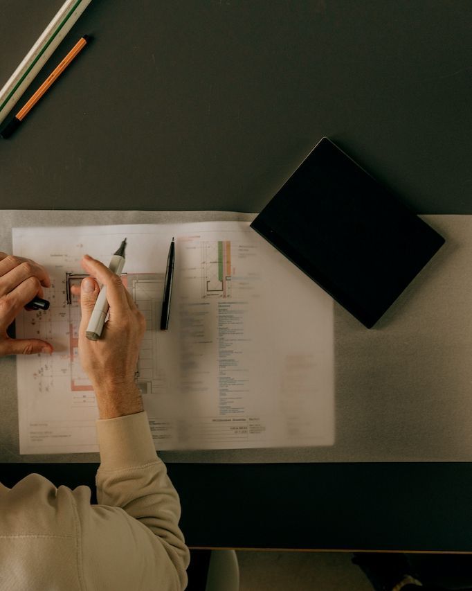 A Person Making House Plans For Renovations — Imperial Build Co. in Gungahlin, ACT