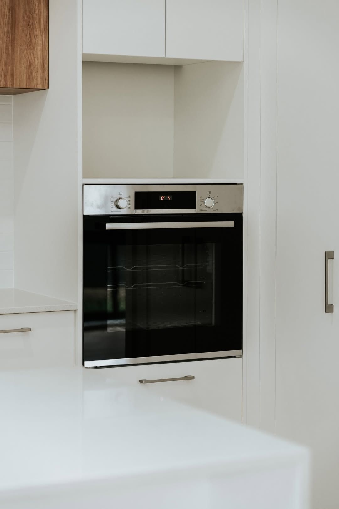 A Kitchen With White Cabinets and Counter Tops is Being Remodeled — Imperial Build Co. in Coombs, ACT