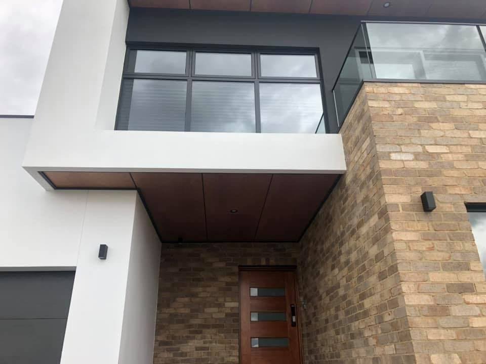 A Grey, White And Brcik House With Wooden Door — Imperial Build Co. in Belconnen, ACT