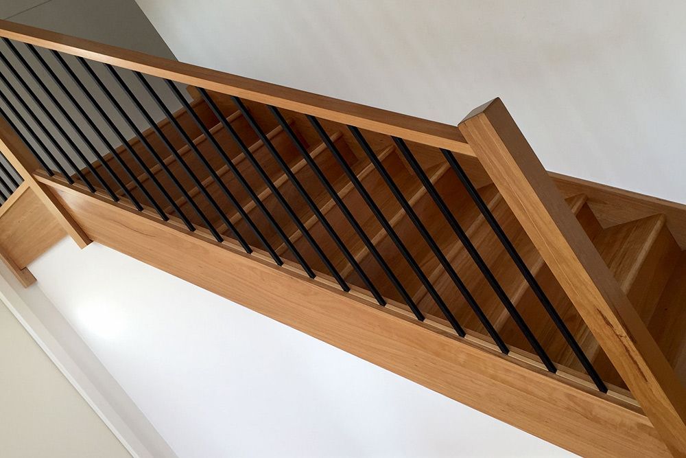 A Wooden Staircase With a Black Railing in a House — Imperial Build Co. in  Coombs, ACT