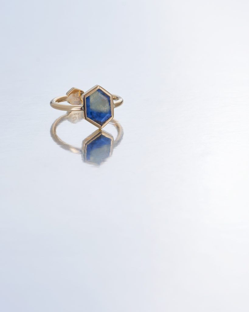 Hexagonal gold ring with blue stone